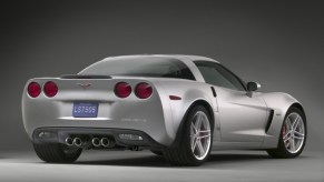 A silver, 200 MPH C6 Corvette Z06 shows off its rear-end styling and wide tires.