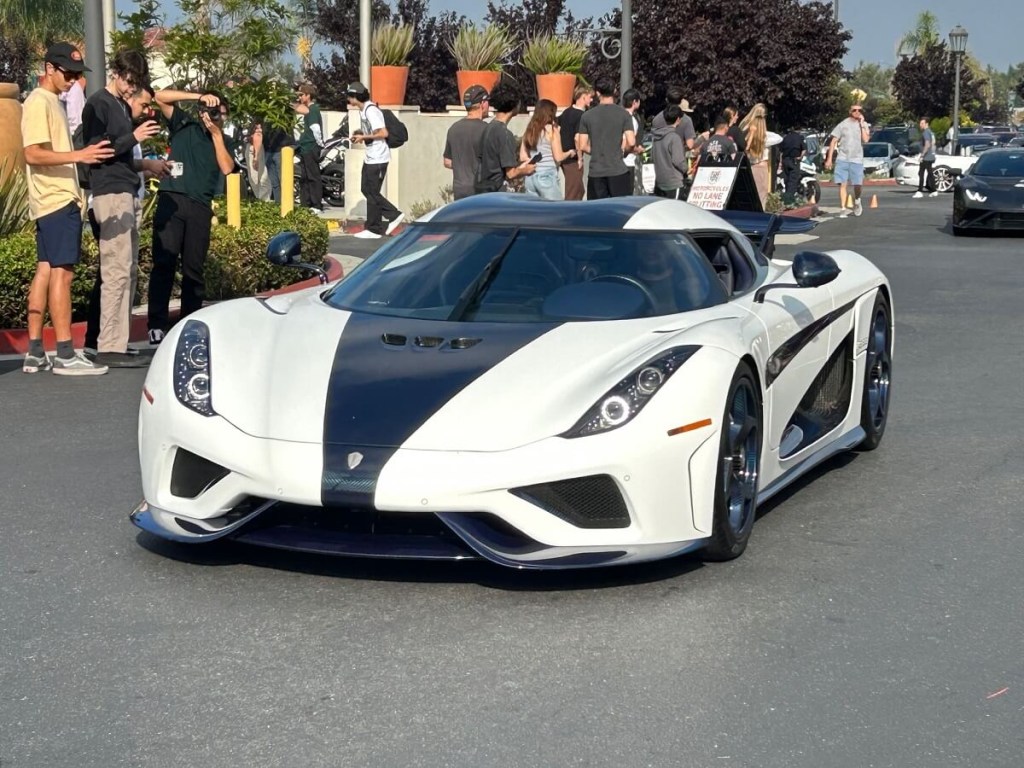 A white and black Koenigsegg Regera cruises by at Cars and Coffee in San Clemente.