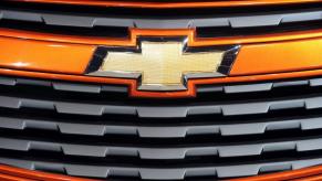 An orange 2011 Chevy Cruze compact car displaying the Chevrolet bow tie symbol