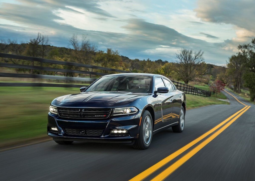A 2015 Dodge Charger AWD sports car driving down a road