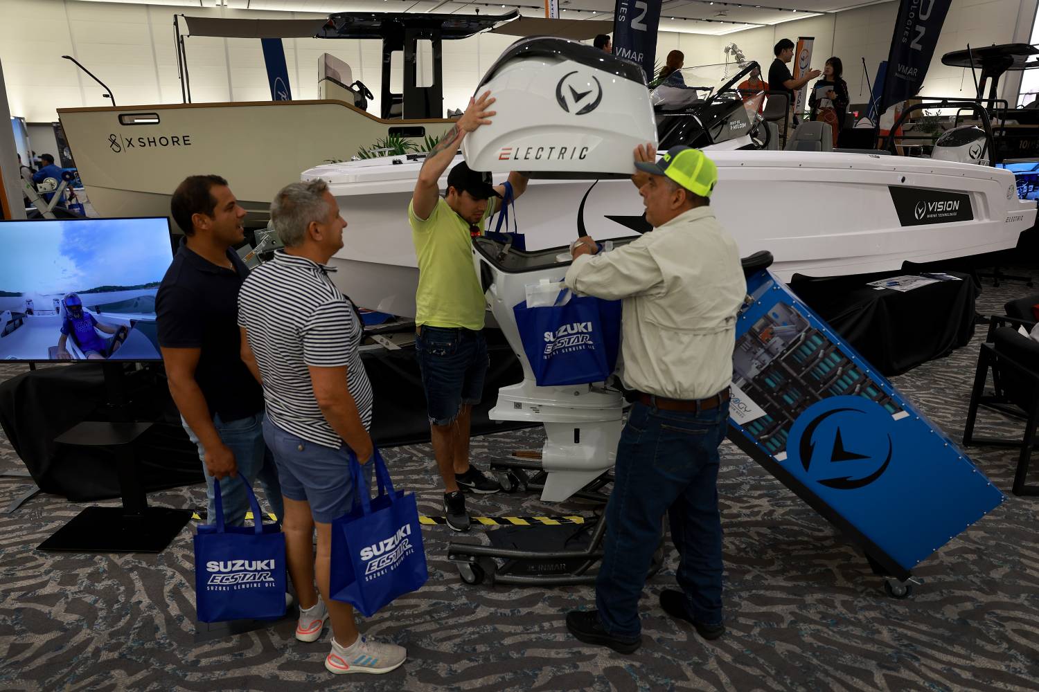 People checking out an electric boat at a convention.