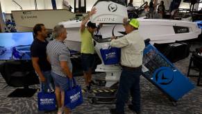 People checking out an electric boat at a convention.