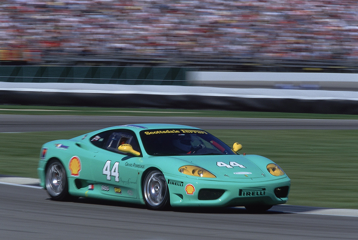 Green and yellow Ferrari 360 race car driving on a race track