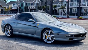 Front 3/4 view of a blue / silver Ferrari 456 coupe with manual transmission and V12 for sale on Doug Demuro auction site Cars and Bids