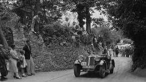 A black and white photo of the first BMW car at a race.