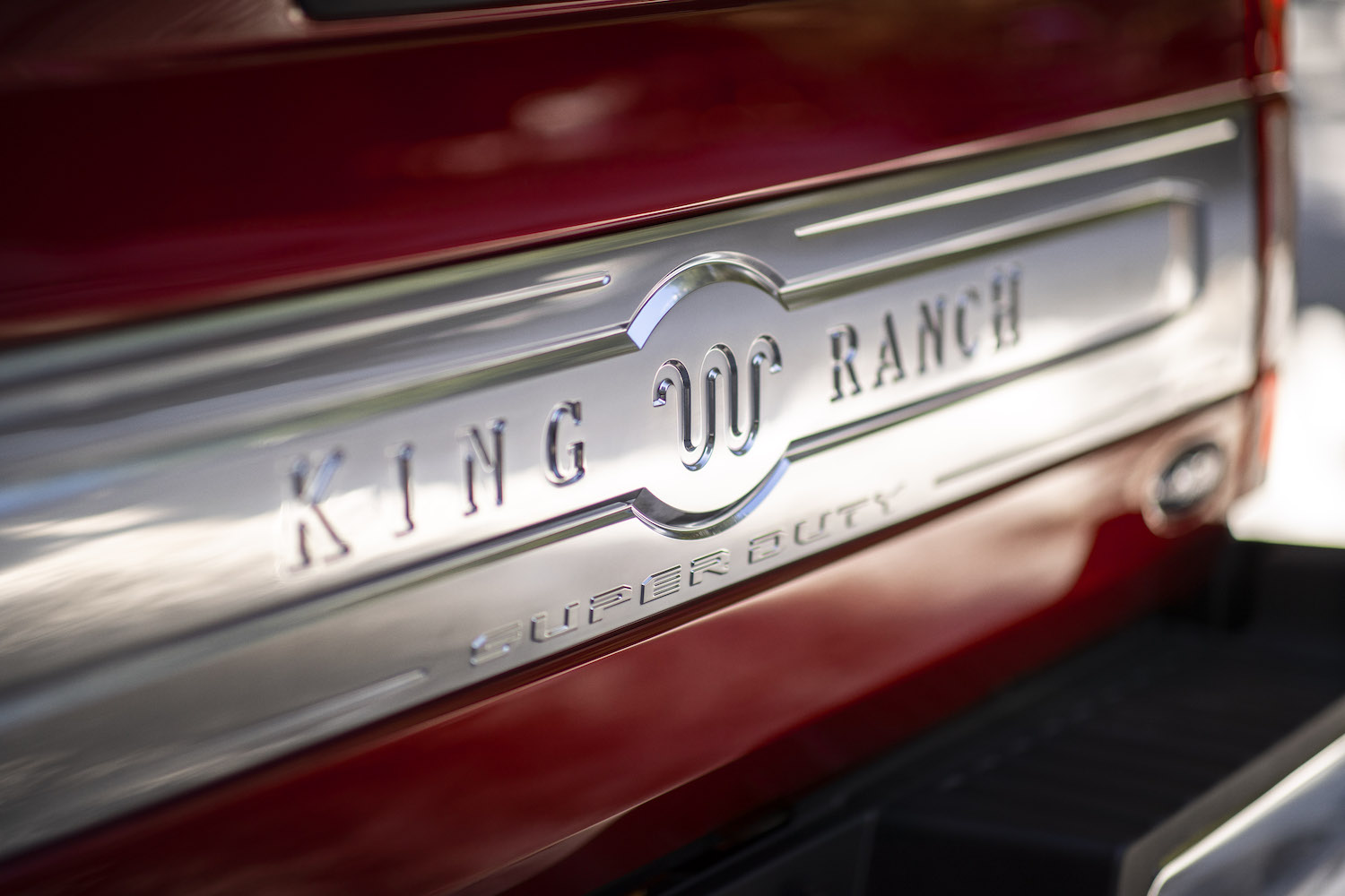 The King Ranch logo and name on the red tailgate of a top-trim Super Duty F-250 truck.