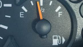 Black fuel gauge with white "E" and "F" letters on either end of the needle.