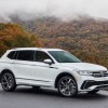 White fully loaded 2024 Volkswagen Tiguan driving on a foggy road.