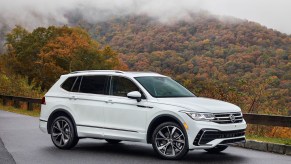 White fully loaded 2024 Volkswagen Tiguan driving on a foggy road.