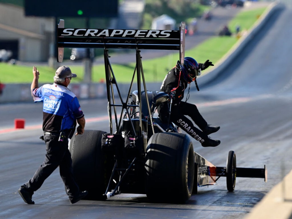 Mike Salinas Scrapper Top Fuel dragster hopping out of car after pass