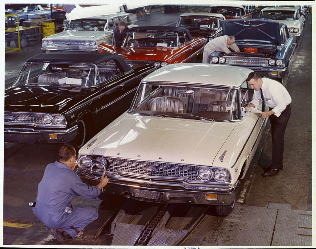 Shiny new 1963 Fords on the finish assembly line 