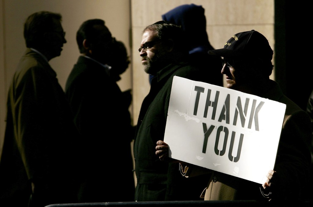 Man with "Thank You" sign