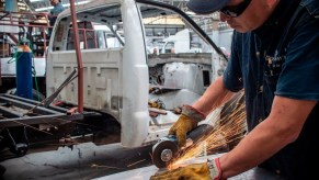 A Mexican factory worker assembles a heavy-duty pickup truck.