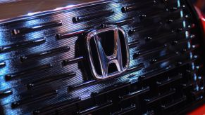 The Honda logo on the front grille of an SUV. Car sales for Honda and other manufacturers are up this year.