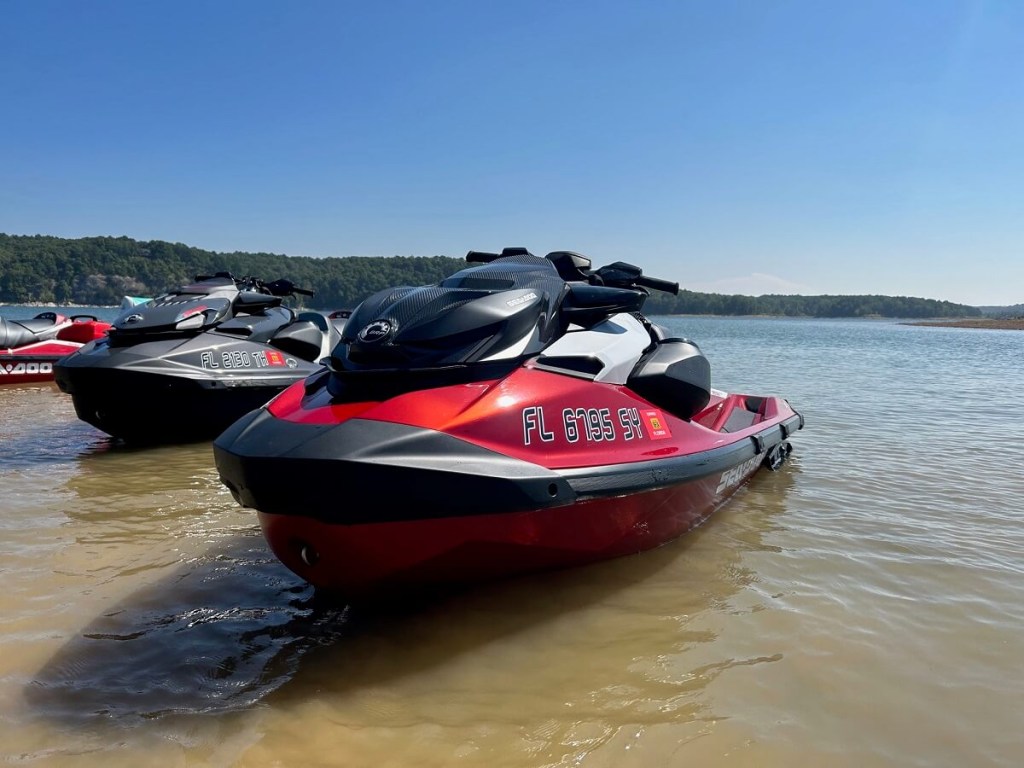 A bright-red Sea-Doo RPX-T sits by the shoreline. 