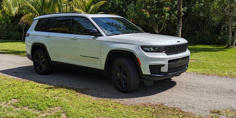 A white 2023 Jeep Grand Cherokee L midsize three-row SUV is parked outdoors. 