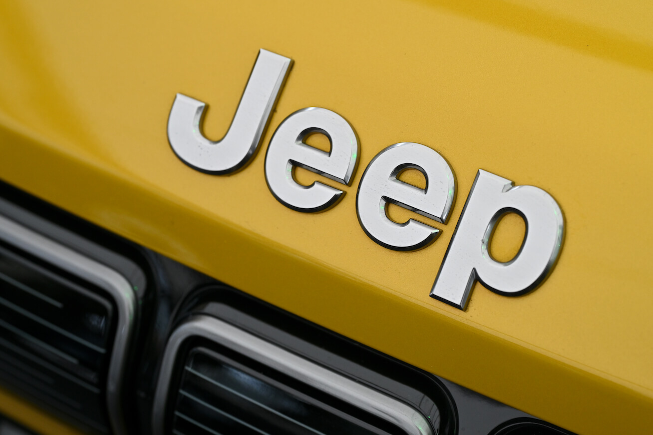 A Jeep bonnet badge logo is displayed during the Fully Charged Live UK. Jeep resale value for the Wrangler is high.