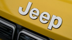 A Jeep bonnet badge logo is displayed during the Fully Charged Live UK. Jeep resale value for the Wrangler is high.
