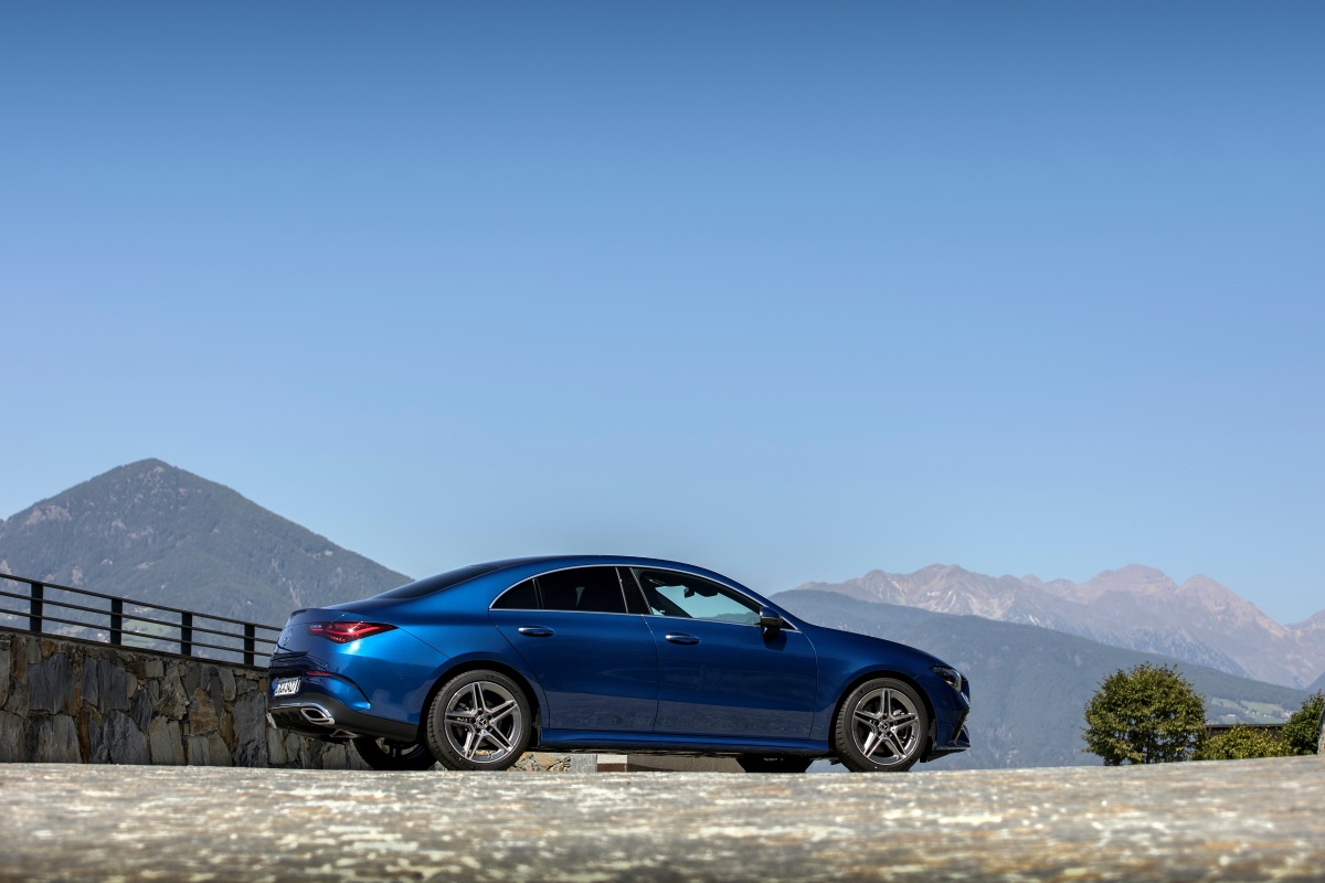 A blue Mercedes-AMG CLA 45 all-wheel drive sports car parked in the mountains