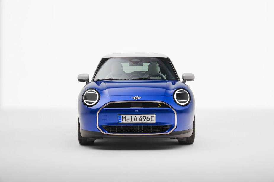 Blue Mini Cooper SE against a white backdrop. Mini sales aren't doing too hot this year.