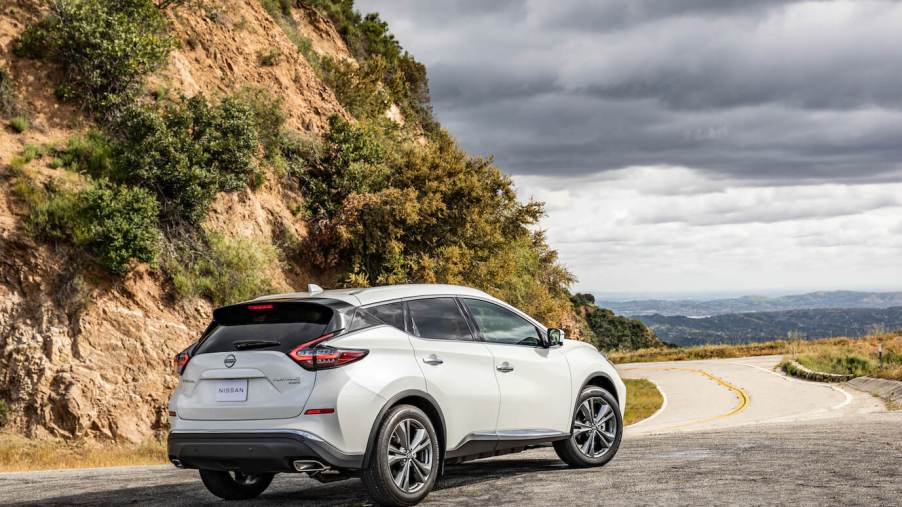 Nissan's most reliable SUV, the 2023 Nissan Murano, pictured in white parked ahead of a cliff.
