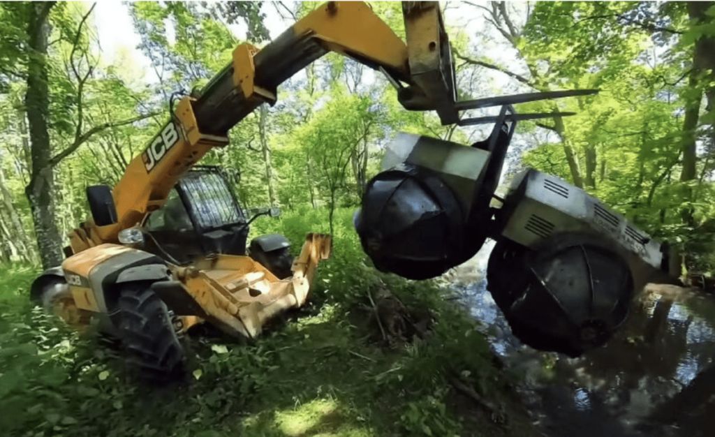 Colin Furze's amphibian Rhino Tank being pulled from the muck