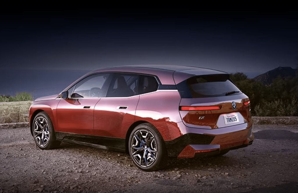 2024 BMW iX EV SUV parked on dark background
