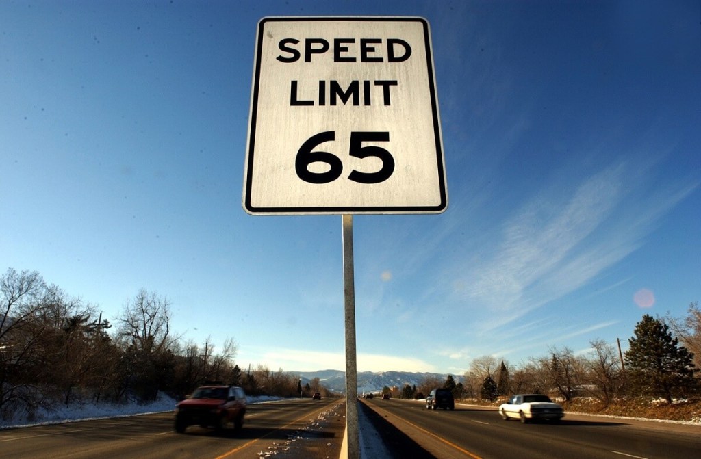 A 65 MPH speed limit warns drivers not to exceed the limit.