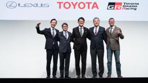 Toyota's CEO and other board members pose for a photo at an event.