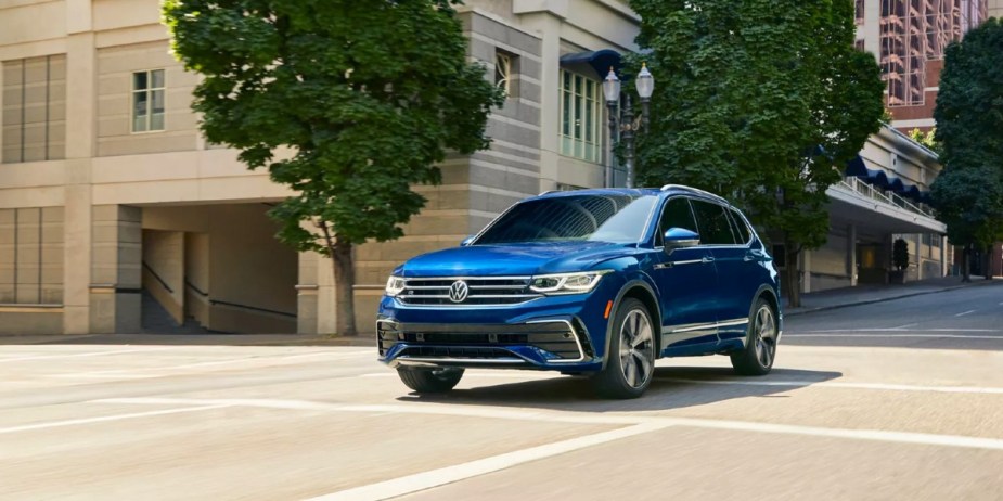 A blue Volkswagen Tiguan SUV is driving. 