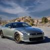 A 2024 Nissan GT-R T-Spec sports car coupe model parked on a empty asphalt road in the desert