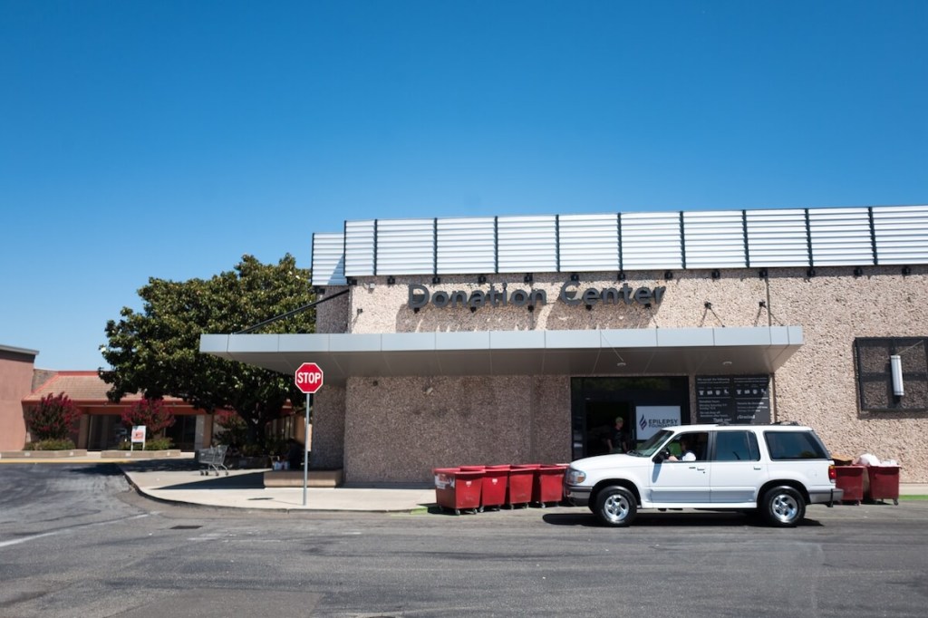 A car sits near a charity donation center