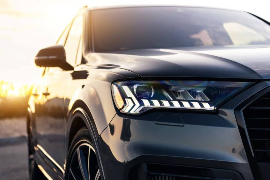 A closeup shot of the front headlight on a silver-gray 2021 Audi Q7 full-size luxury crossover SUV model