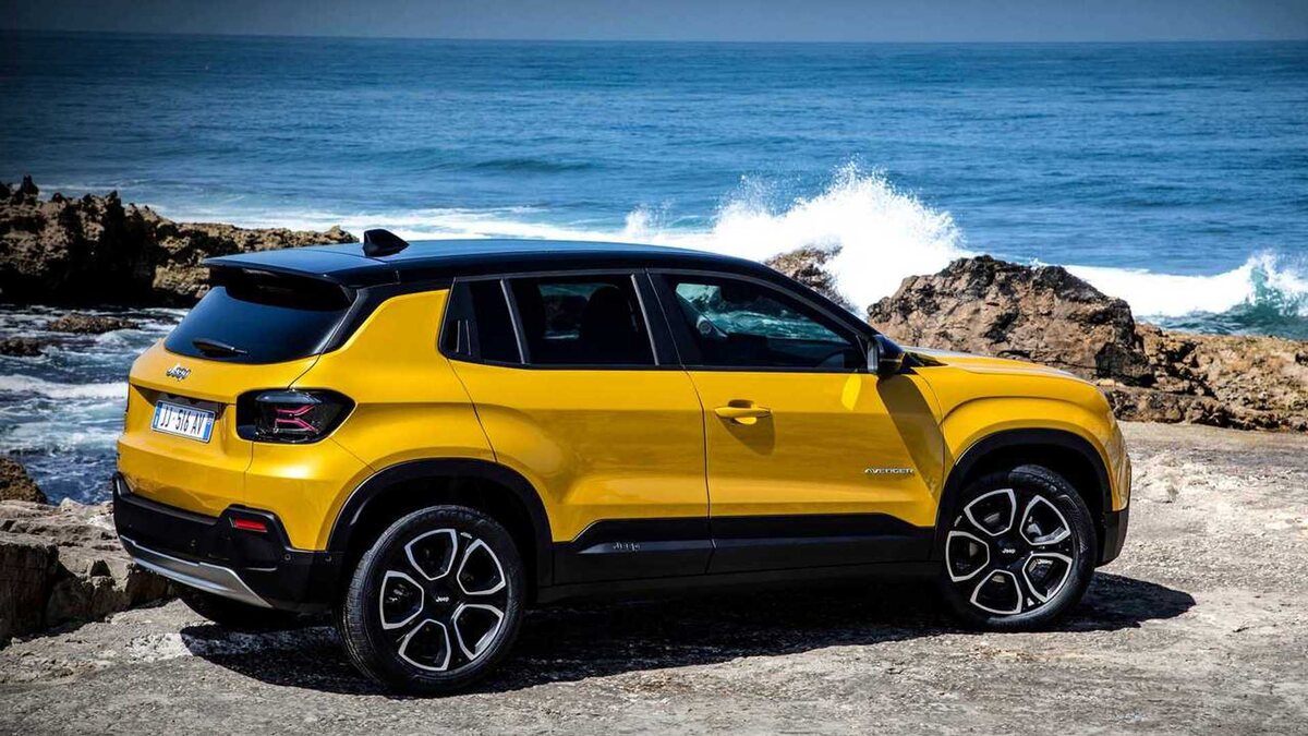 Yellow 2023 Jeep Avenger EV SUV with ocean background
