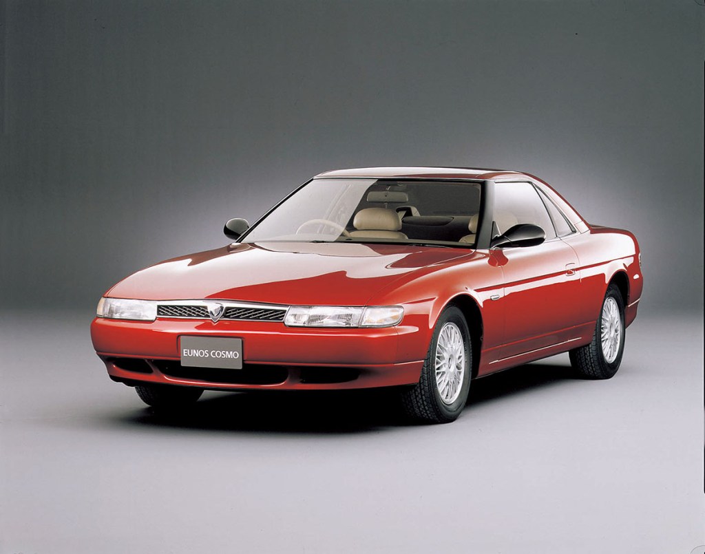 front 3/4 view of a red Mazda Eunos Cosmo sports coupe, the rare and forgotten rotary car