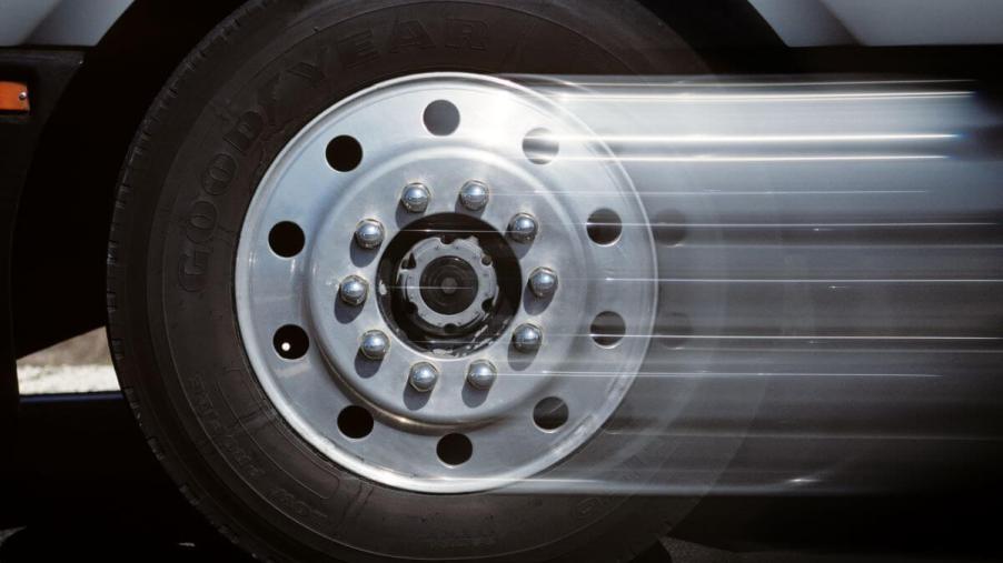A closeup shot of a tire and hubcap on a pickup truck that begins to blur as it moves from acceleration