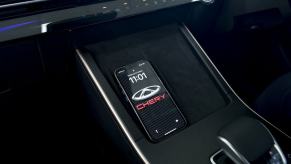 A wireless charging station featured inside a Cherry Omoda 5 model from the Chinese luxury car brand