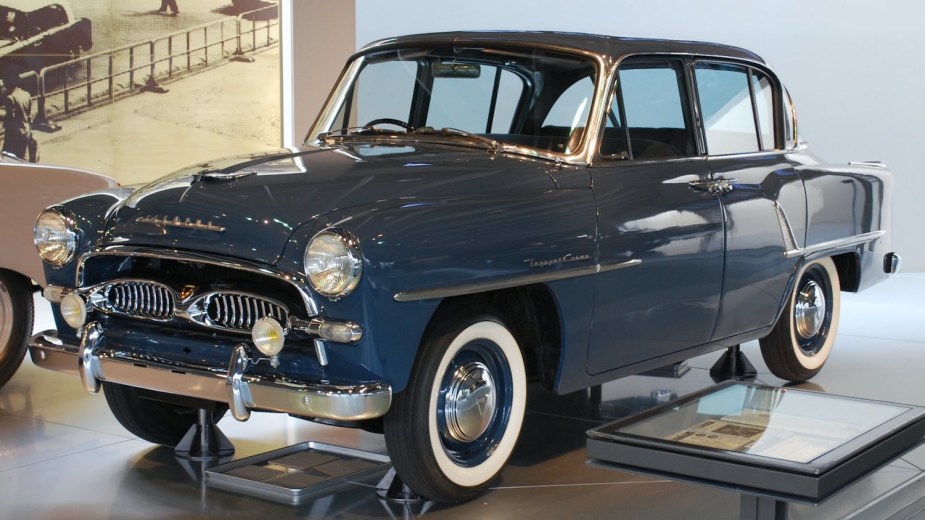The original Toyota Crown luxury sedan parked in a museum.