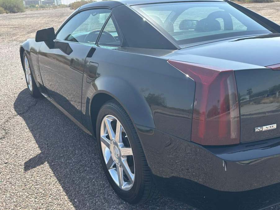 Closeup of the tail light in a black Cadillac XLR luxury sportscar coupe.