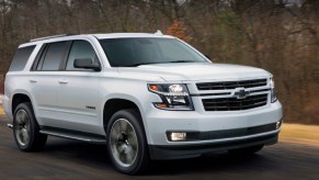 A 2018 Chevrolet Tahoe full-size SUV is driving on the road.