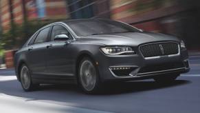 A gray 2018 Lincoln MKZ luxury car cruises down a city street.