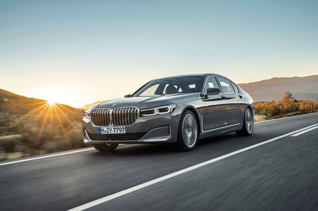 A gray 2020 BMW 7 Series shows off its front-end styling as the 740i takes on a country road.