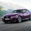 A purple 2023 BMW 2 Series, smaller than the higher-tier 3 Series, drives on a mountain road.