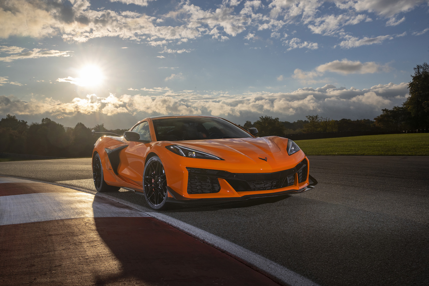 Front view of 2023 Chevrolet Corvette Z06 in Amplify Orange Tint on a track.