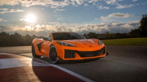 Front view of 2023 Chevrolet Corvette Z06 in Amplify Orange Tint on a track.