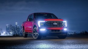 The 2023 Ford F-150 parked near a city at night