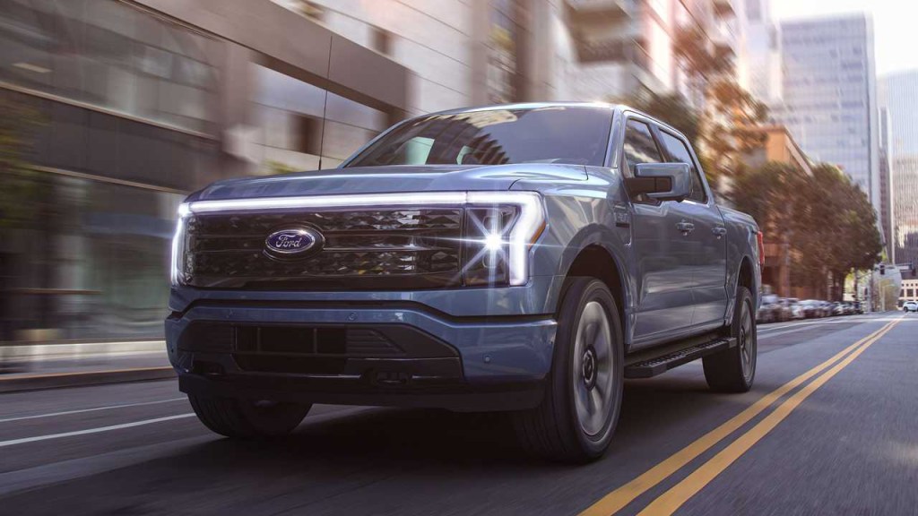 The 2023 Ford F-150 Lightning driving through the city 