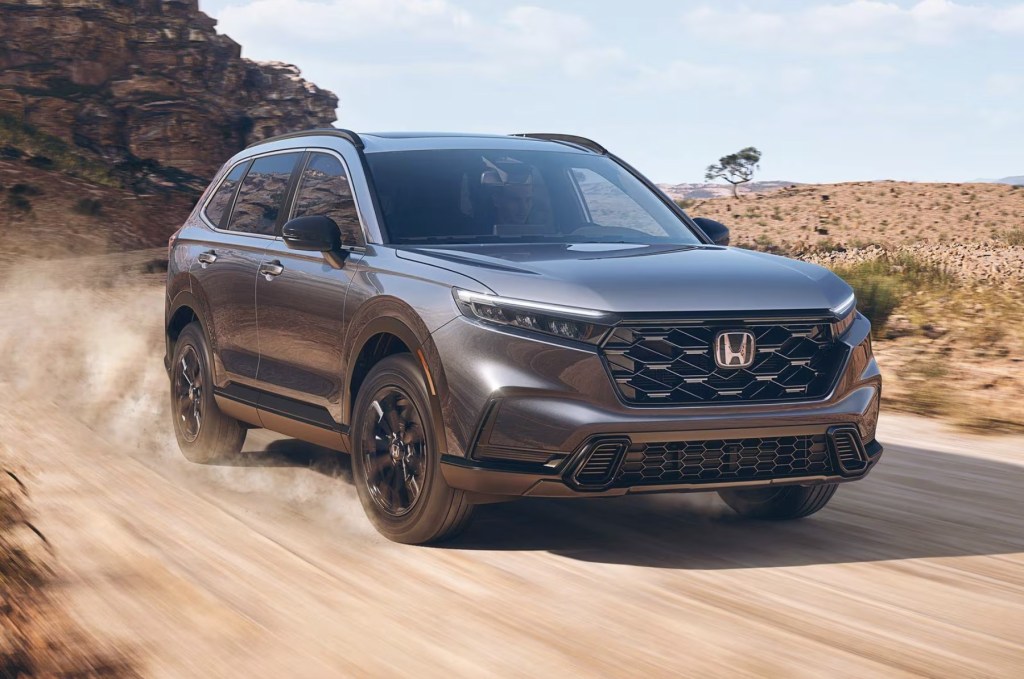 The 2023 Honda CR-V Hybrid driving on a dirt road