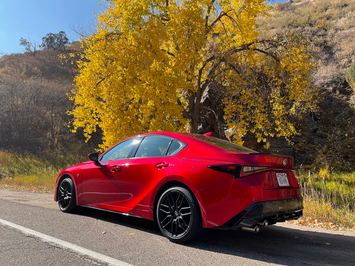 A rear corner view of the 2023 Lexus IS 500 on a canyon road