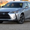 Front 3/4 view of silver 2023 Lexus UX 250h hybrid compact SUV during fuel economy test